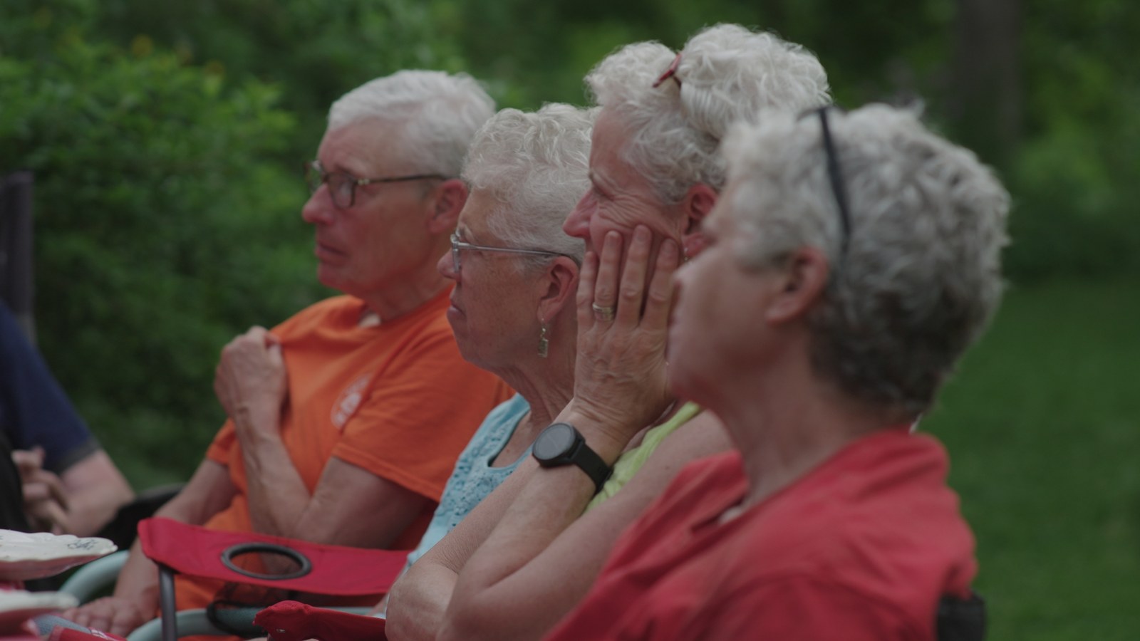 Four siblings sitting together outside